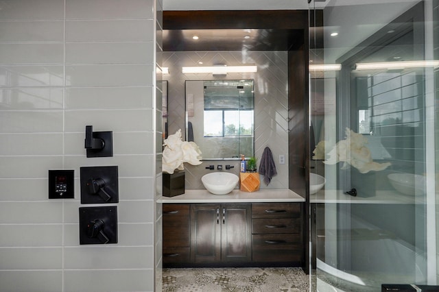 bathroom featuring an enclosed shower and vanity