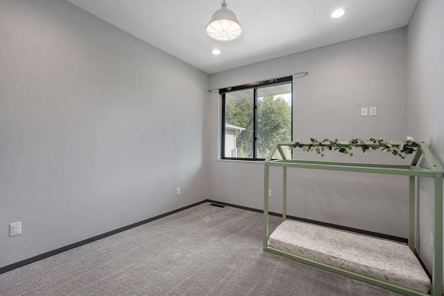 unfurnished bedroom with carpet flooring and a textured ceiling