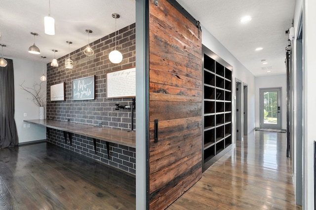 hallway featuring a textured ceiling and dark hardwood / wood-style flooring