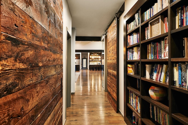 corridor with hardwood / wood-style flooring