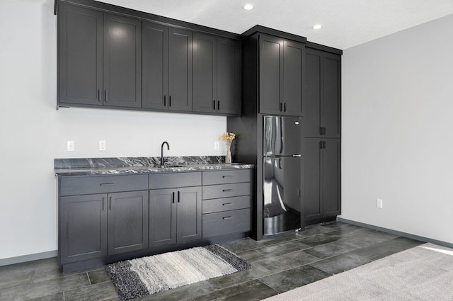 kitchen featuring stainless steel fridge and sink