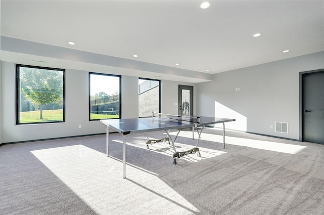 recreation room with light colored carpet and a wealth of natural light