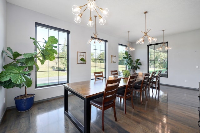 dining space with dark hardwood / wood-style floors and a chandelier