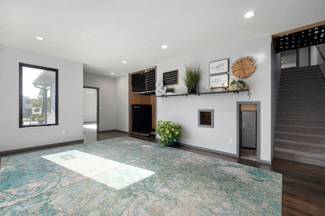 unfurnished living room with dark hardwood / wood-style floors