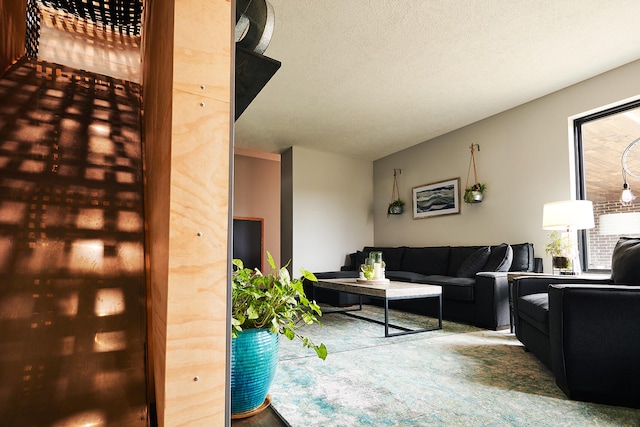 carpeted living room featuring a textured ceiling