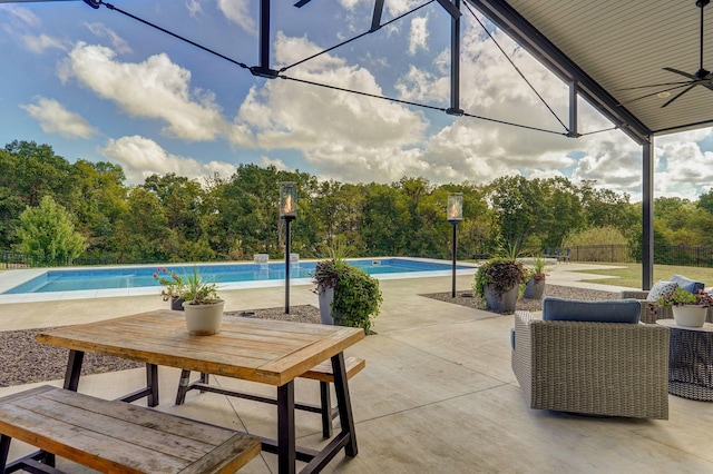 view of patio / terrace with ceiling fan and a fenced in pool