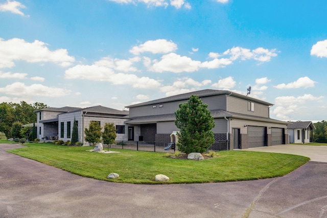 prairie-style home with a garage and a front lawn