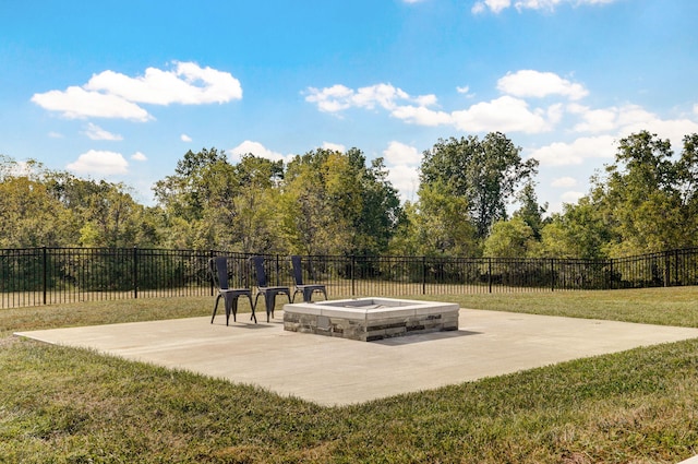 view of property's community with a lawn, a patio area, and an outdoor fire pit