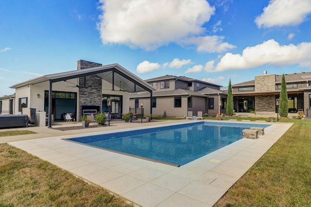 view of swimming pool with a yard and a patio area