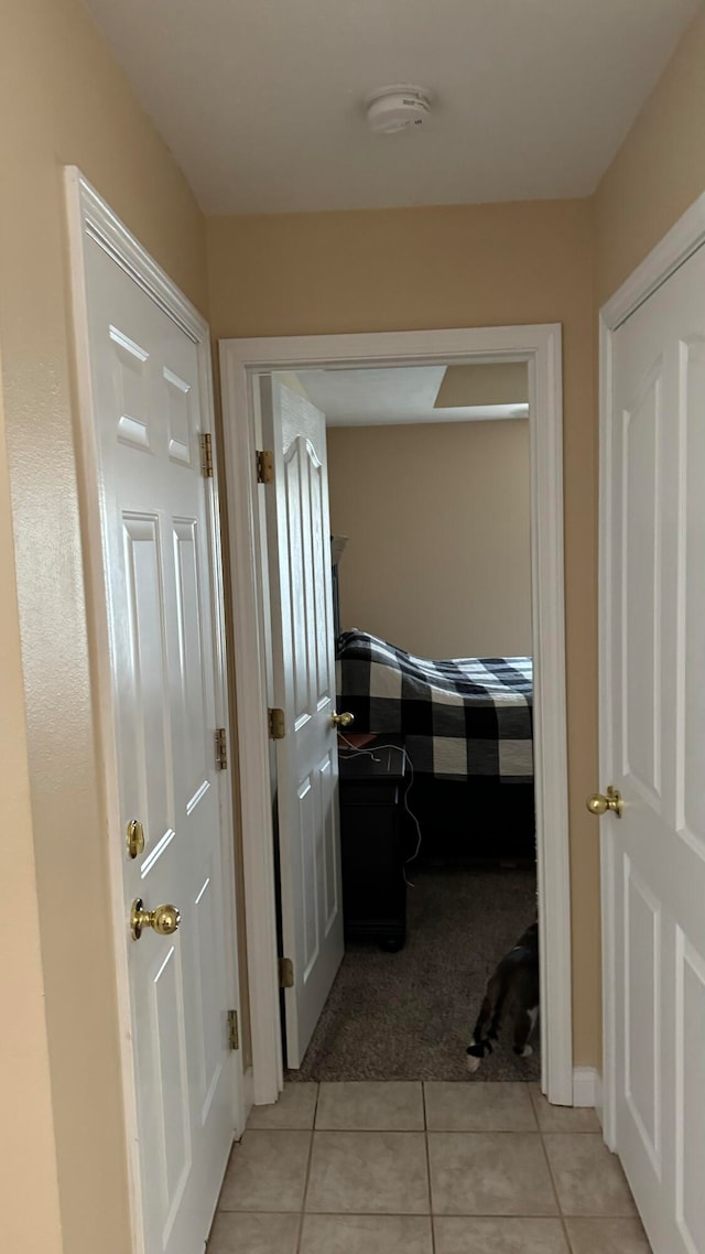 hall featuring light tile patterned floors