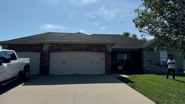 view of front of house featuring a garage and a front lawn