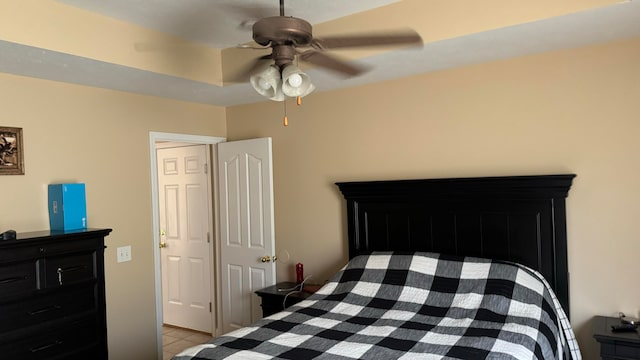 bedroom with ceiling fan and light tile patterned floors