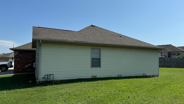 view of side of home featuring a lawn