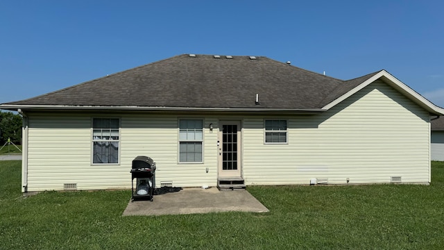 back of property with a patio and a lawn