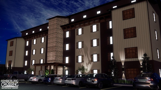property at night featuring uncovered parking