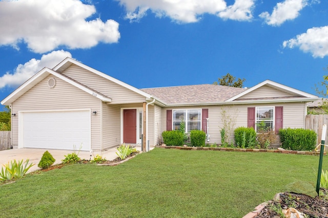 ranch-style house featuring a garage and a front lawn