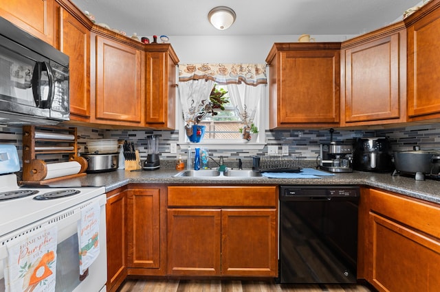 kitchen with light hardwood / wood-style floors, sink, tasteful backsplash, and black appliances