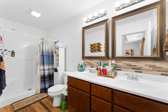 bathroom with hardwood / wood-style flooring, toilet, curtained shower, and vanity