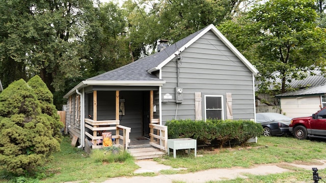 bungalow-style house with roof with shingles