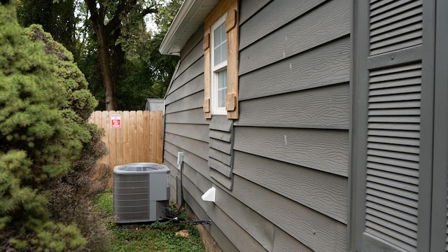view of home's exterior with fence and cooling unit