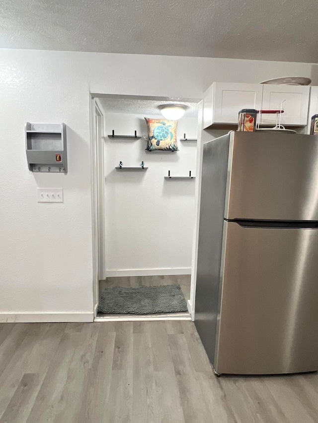 interior space with hardwood / wood-style floors and a textured ceiling