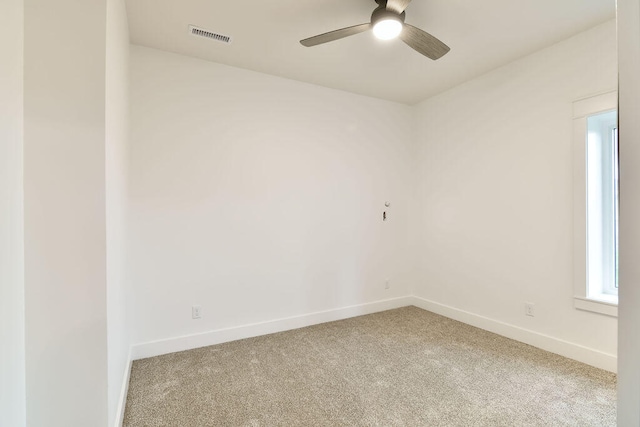 carpeted spare room with ceiling fan