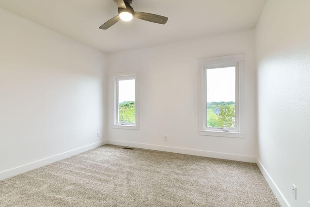 carpeted empty room featuring ceiling fan