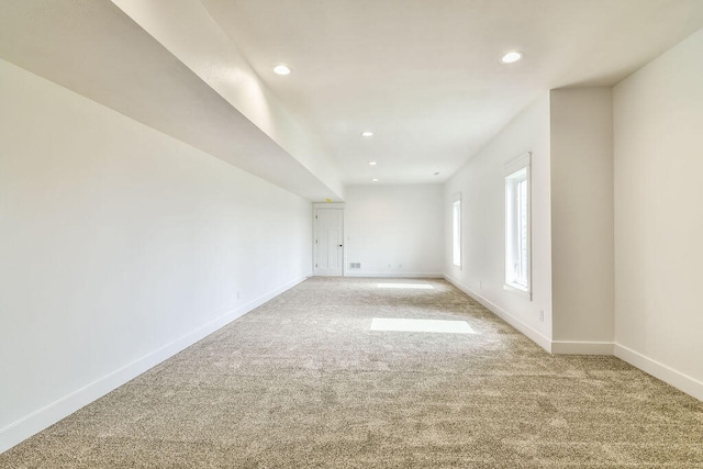 unfurnished room featuring light carpet