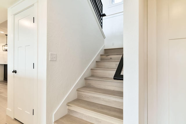 stairs with hardwood / wood-style flooring