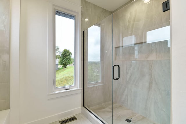 bathroom featuring tile patterned flooring and an enclosed shower