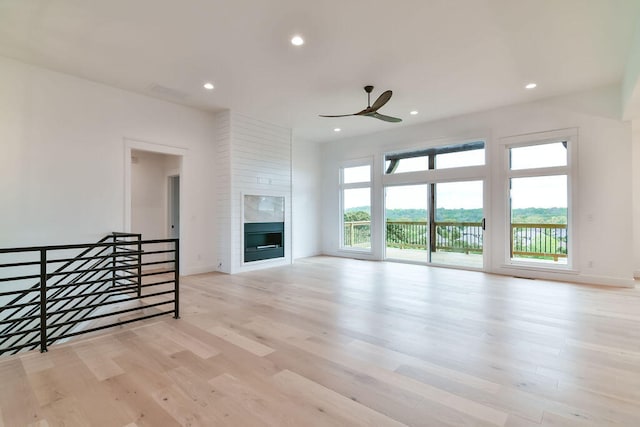 unfurnished living room with ceiling fan and light hardwood / wood-style floors