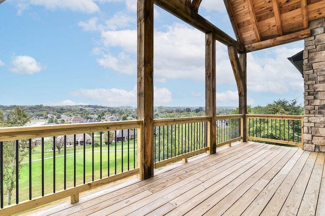 wooden terrace featuring a yard