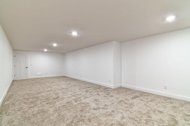 spare room featuring light colored carpet