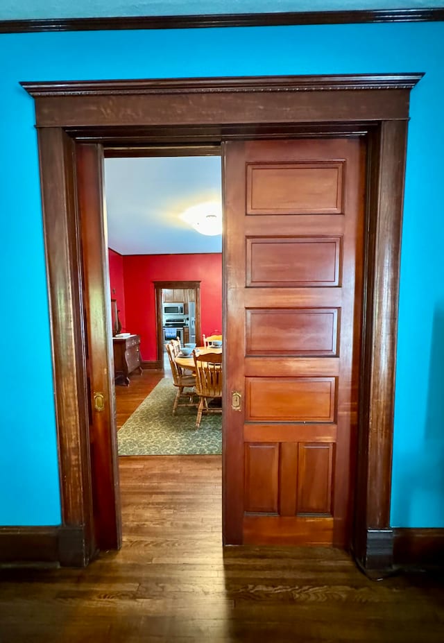 hallway with dark hardwood / wood-style floors