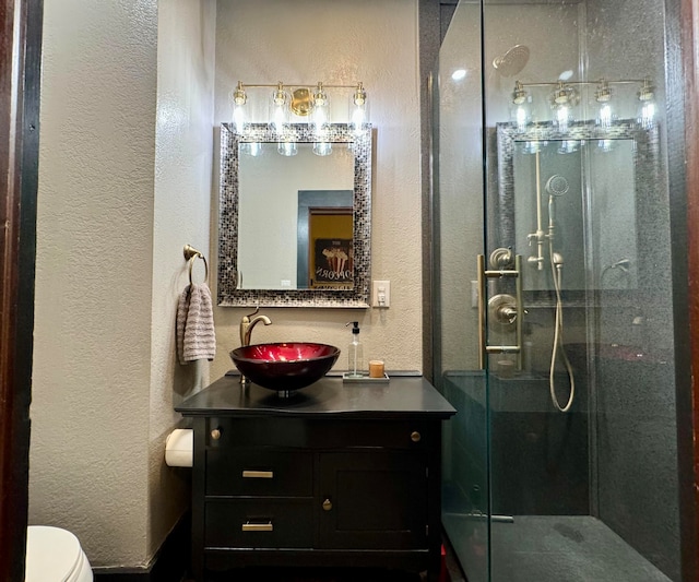 bathroom with vanity, toilet, and walk in shower