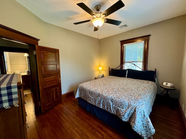 bedroom with dark hardwood / wood-style floors and ceiling fan