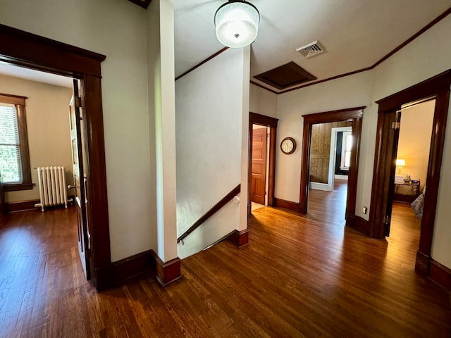 hall with dark hardwood / wood-style flooring and radiator heating unit