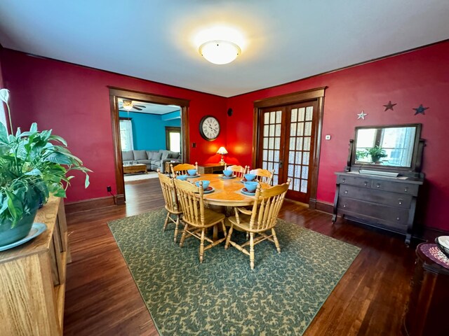 dining space featuring ceiling fan, french doors, and dark wood-type flooring