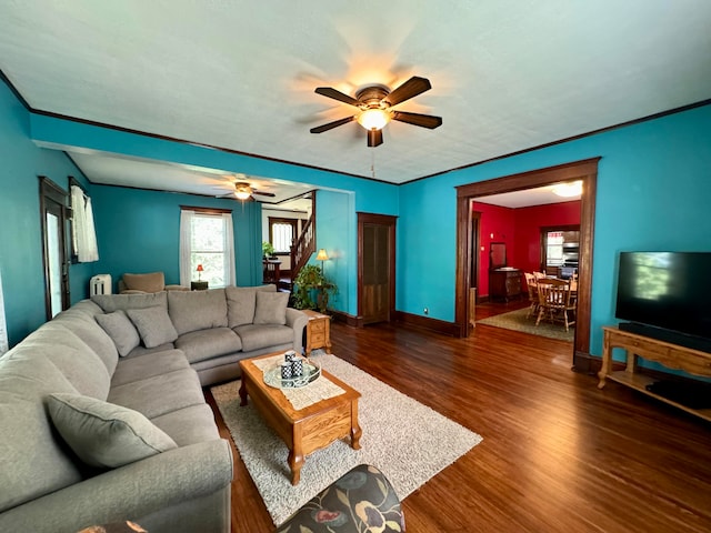 living room with ceiling fan and dark wood-type flooring