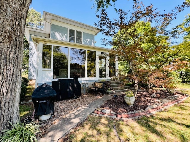 back of house featuring a sunroom