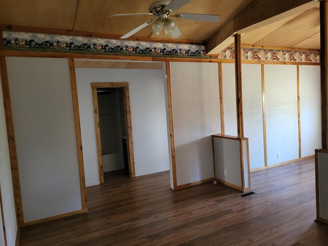 unfurnished room featuring dark hardwood / wood-style floors, vaulted ceiling, and ceiling fan