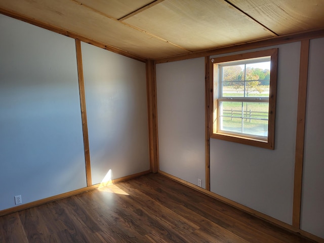 unfurnished room with dark hardwood / wood-style flooring