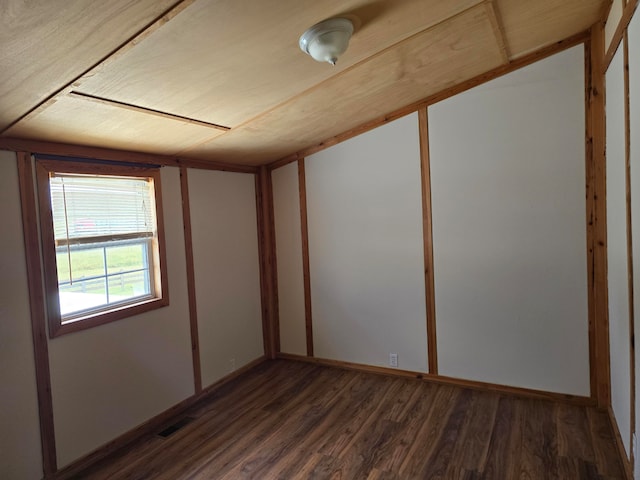 spare room featuring dark hardwood / wood-style flooring