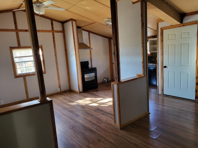 interior space featuring black appliances, ceiling fan, wall chimney exhaust hood, dark wood-type flooring, and vaulted ceiling