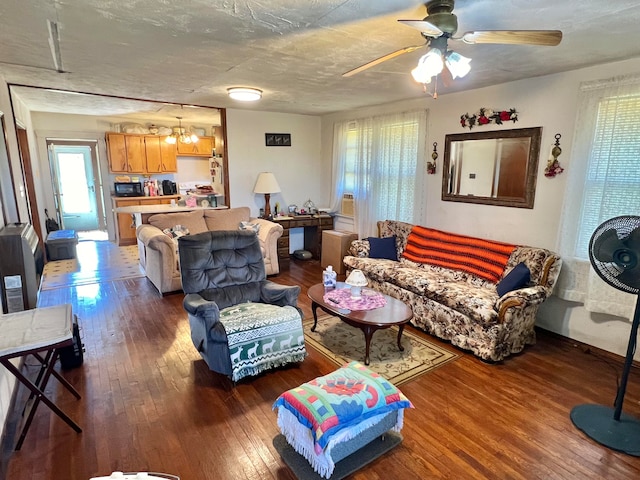 living room with hardwood / wood-style floors, a textured ceiling, and ceiling fan