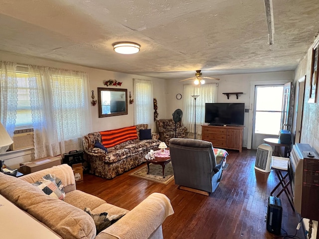 living room with a textured ceiling, cooling unit, dark hardwood / wood-style floors, and ceiling fan