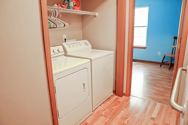 laundry area with light wood-type flooring and independent washer and dryer