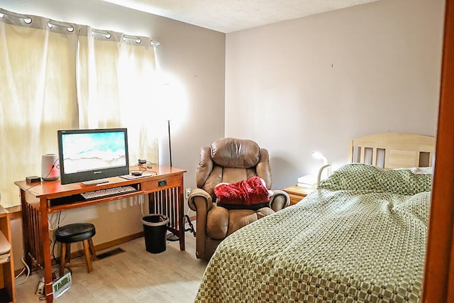 bedroom featuring wood-type flooring and a textured ceiling