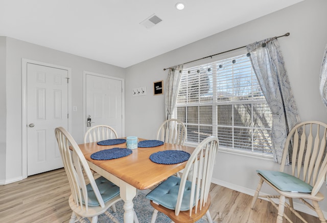 dining area with light hardwood / wood-style flooring and plenty of natural light