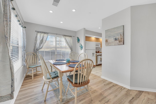 dining space with light hardwood / wood-style flooring